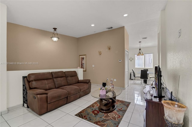 living area with light tile patterned floors, baseboards, visible vents, and recessed lighting