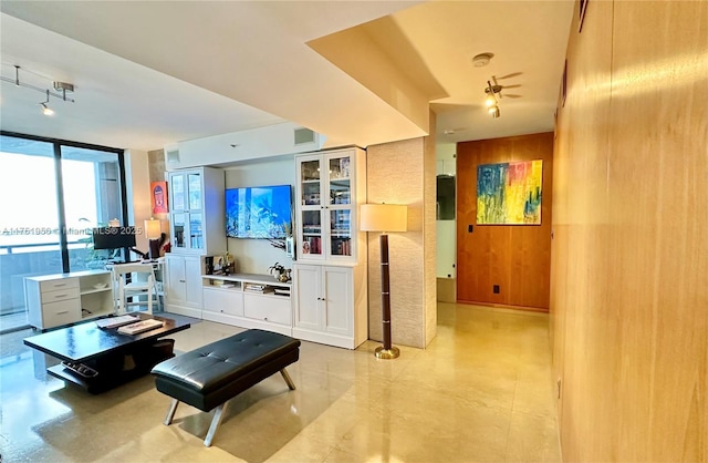 living room featuring wood walls and expansive windows