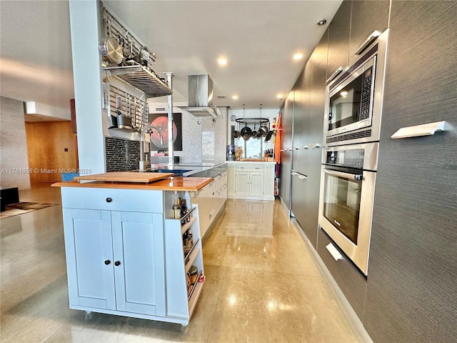 kitchen with open shelves, wood counters, recessed lighting, stainless steel appliances, and island range hood