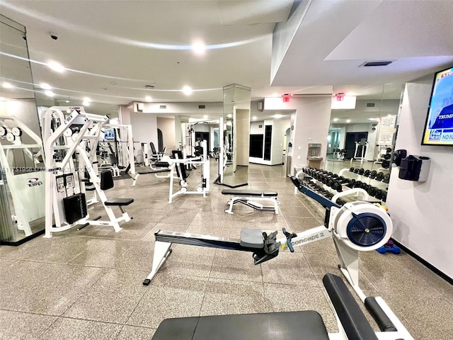 exercise room with visible vents and baseboards