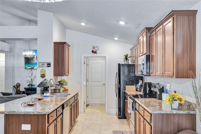 kitchen featuring appliances with stainless steel finishes, brown cabinetry, and a sink