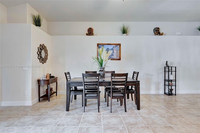 dining space featuring baseboards and light tile patterned floors