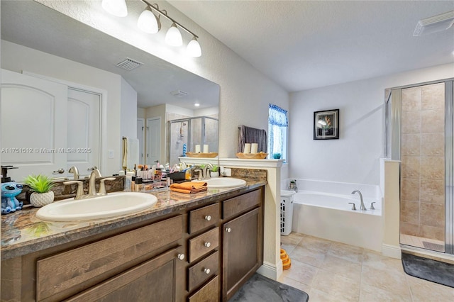 full bath with a bath, a stall shower, a sink, and visible vents