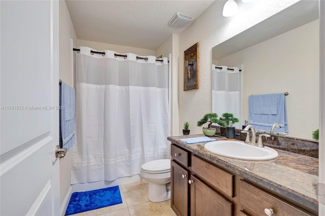 full bath featuring visible vents, toilet, vanity, a textured ceiling, and tile patterned flooring