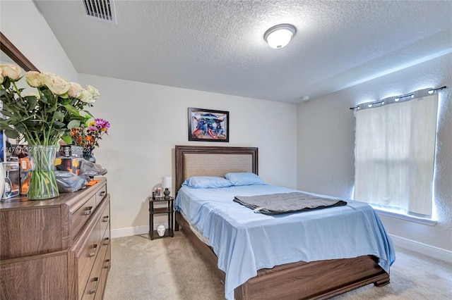 bedroom with light carpet, baseboards, and visible vents