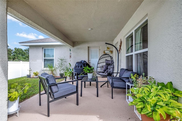 view of patio / terrace with fence and an outdoor hangout area