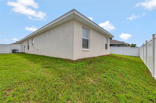 view of property exterior featuring a fenced backyard, a yard, and stucco siding