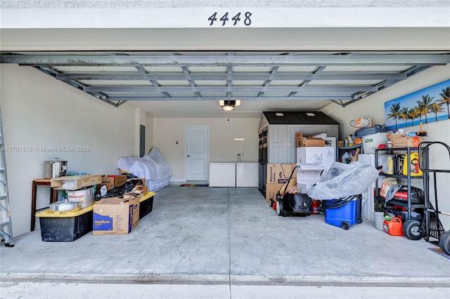 garage featuring refrigerator and a garage door opener