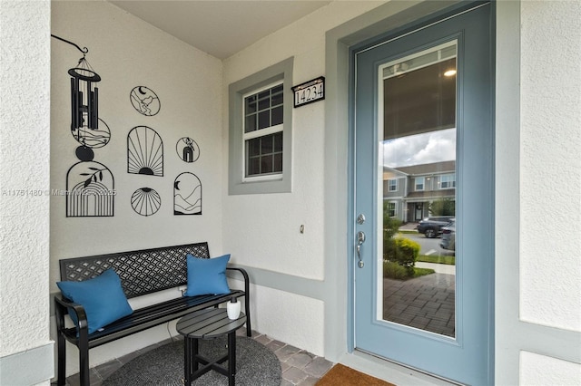 entrance to property featuring stucco siding