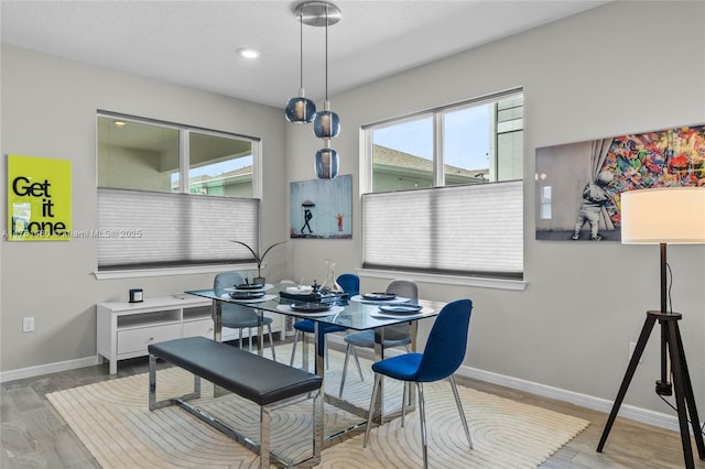 dining area featuring recessed lighting, light wood-style flooring, and baseboards