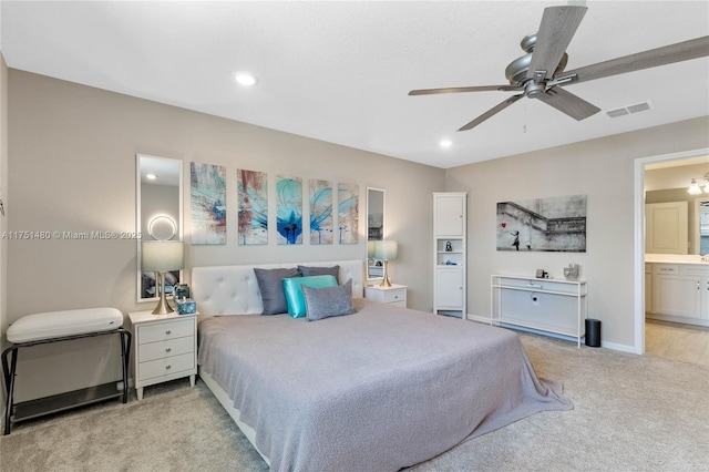 bedroom with light carpet, baseboards, visible vents, ensuite bathroom, and recessed lighting