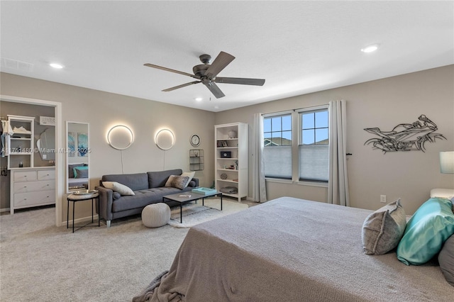 carpeted bedroom with a ceiling fan and recessed lighting