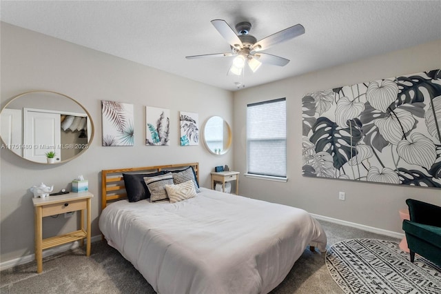 bedroom featuring dark colored carpet, ceiling fan, a textured ceiling, and baseboards