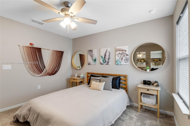 carpeted bedroom featuring baseboards, visible vents, and ceiling fan