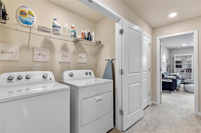 clothes washing area featuring light carpet, laundry area, washing machine and clothes dryer, built in shelves, and recessed lighting