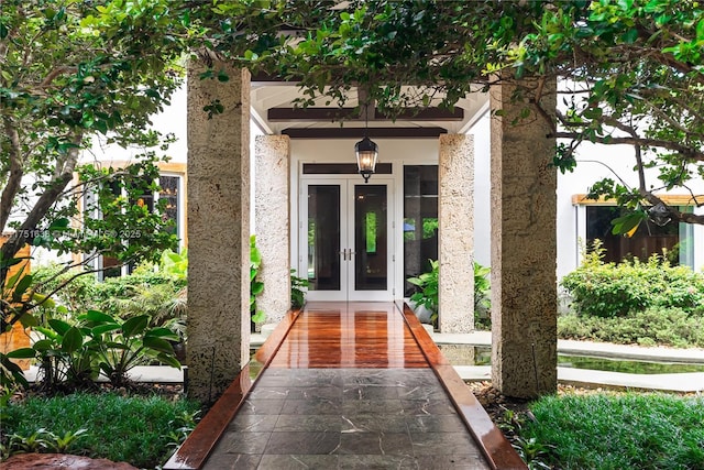 entrance to property with french doors and stucco siding