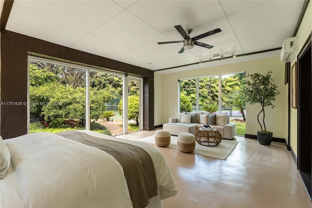 bedroom featuring ceiling fan, a wall unit AC, baseboards, and finished concrete floors