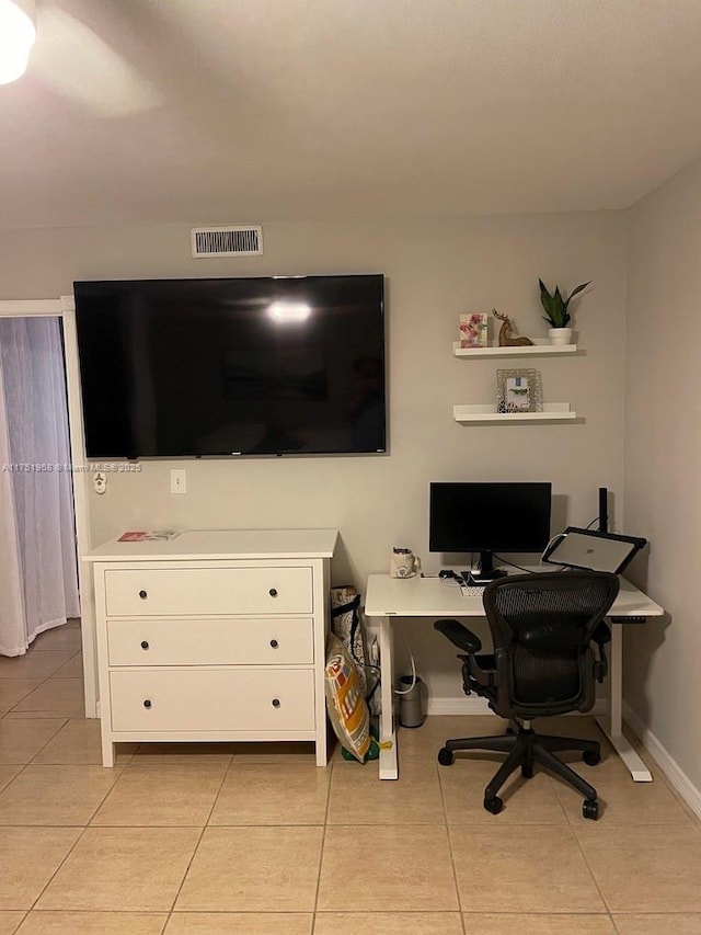 office space with visible vents, baseboards, and light tile patterned floors