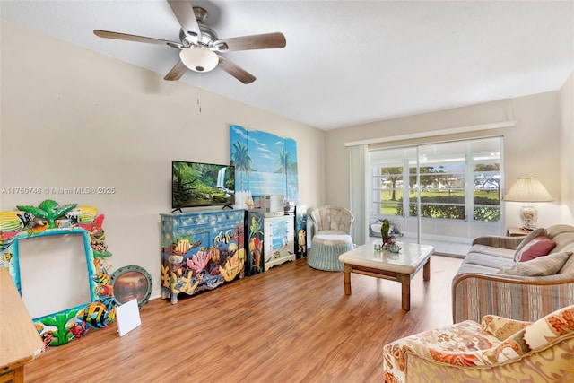 living room featuring ceiling fan and wood finished floors