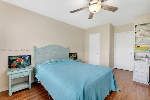 bedroom featuring ceiling fan and dark wood-style flooring