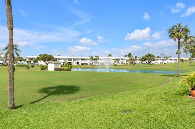 view of home's community featuring a water view and a lawn