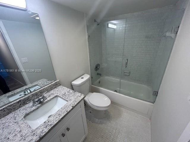 bathroom featuring vanity, toilet, and bath / shower combo with glass door