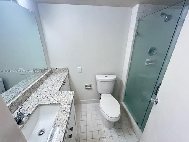 bathroom with toilet, a stall shower, tile patterned flooring, and vanity