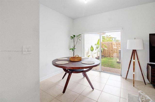 dining room featuring baseboards and light tile patterned floors