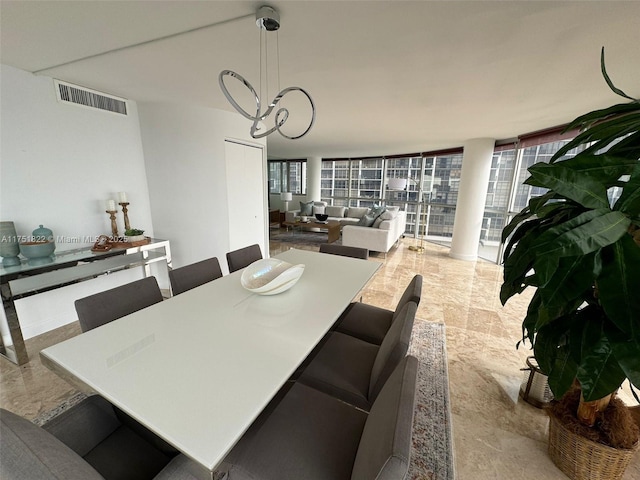 2025 Brickell Ave Unit 901, Miami, FL 33129 - dining room featuring a chandelier and healthy amount of natural light