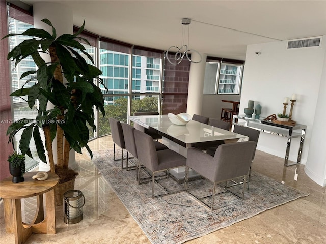2025 Brickell Ave Unit 901, Miami, FL 33129 - dining room featuring a chandelier, plenty of natural light, and baseboards