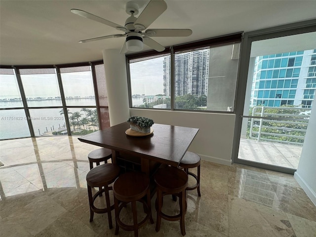 2025 Brickell Ave Unit 901, Miami, FL 33129 - dining area with ceiling fan, baseboards, stone finish flooring, and floor to ceiling windows