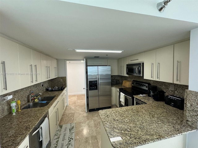 2025 Brickell Ave Unit 901, Miami, FL 33129 - kitchen with stainless steel appliances, a sink, backsplash, and stone counters