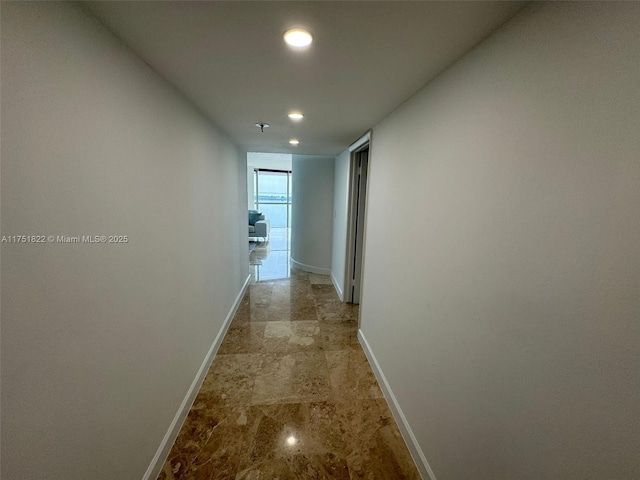 2025 Brickell Ave Unit 901, Miami, FL 33129 - corridor with baseboards, recessed lighting, and light stone finish flooring