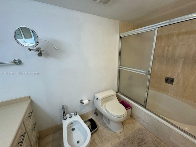 2025 Brickell Ave Unit 901, Miami, FL 33129 - bathroom featuring a bidet, tiled shower / bath, toilet, and tile patterned floors