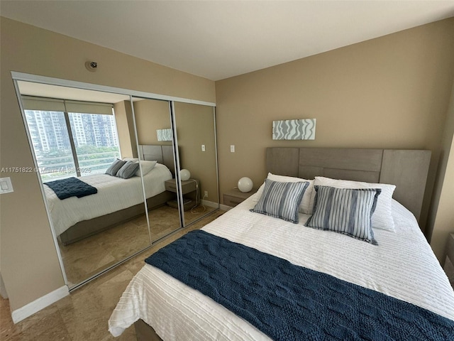 2025 Brickell Ave Unit 901, Miami, FL 33129 - bedroom featuring baseboards and a closet