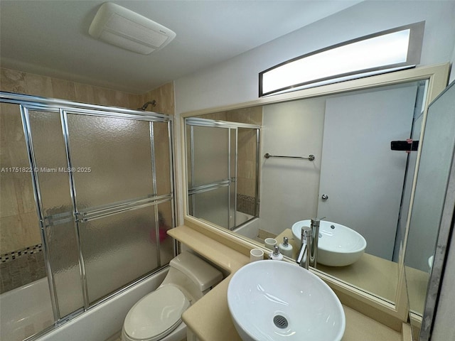 2025 Brickell Ave Unit 901, Miami, FL 33129 - bathroom featuring a sink, enclosed tub / shower combo, and toilet