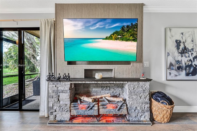 room details featuring crown molding, a stone fireplace, baseboards, and a textured ceiling