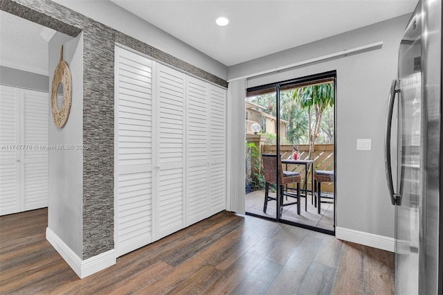 interior space featuring recessed lighting, wood finished floors, and baseboards