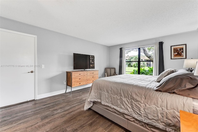 bedroom featuring a textured ceiling, baseboards, and dark wood-style flooring