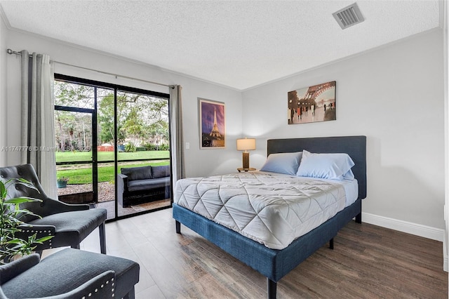 bedroom with baseboards, visible vents, wood finished floors, access to exterior, and a textured ceiling