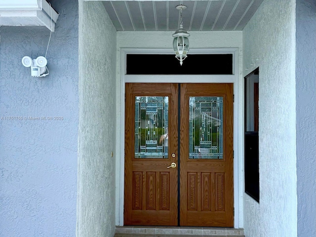 entrance to property featuring stucco siding