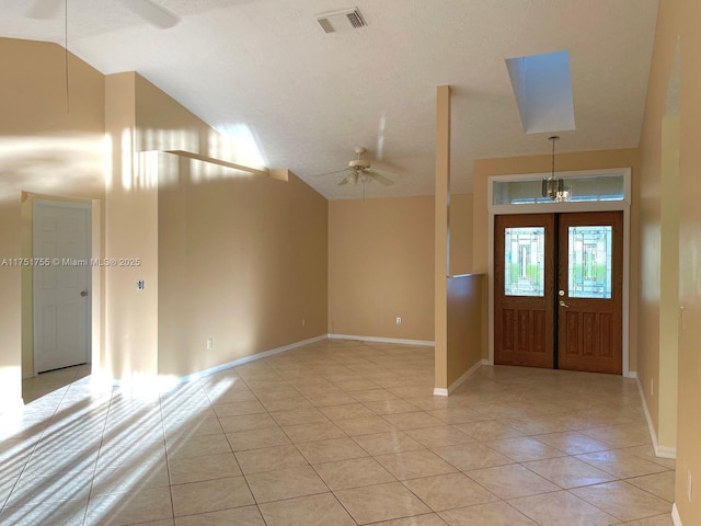 foyer featuring light tile patterned floors, baseboards, visible vents, and a ceiling fan