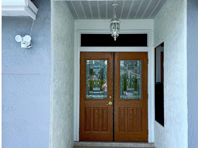 property entrance with stucco siding