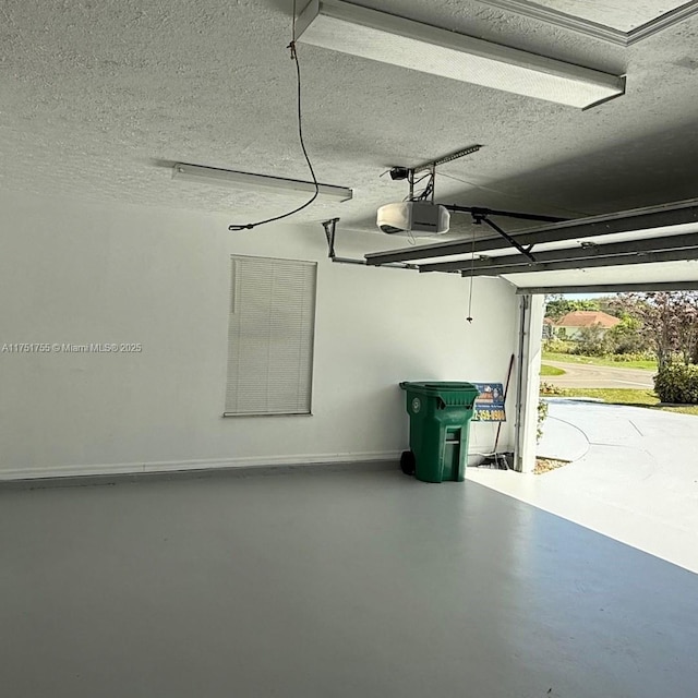 garage featuring baseboards and a garage door opener