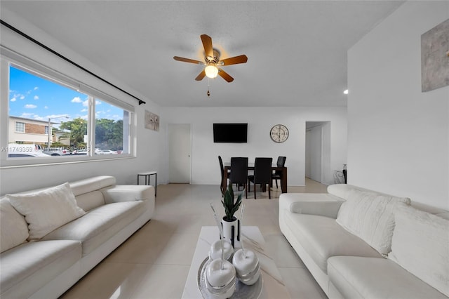 living room featuring a ceiling fan and light tile patterned flooring