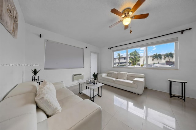 living area with light tile patterned floors, a wall mounted air conditioner, and a ceiling fan