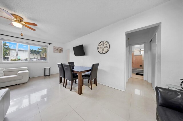 dining room with light tile patterned floors and a ceiling fan