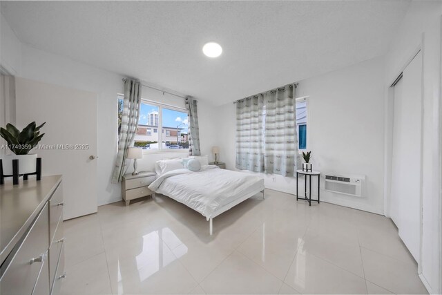 bedroom featuring light tile patterned floors and a wall mounted AC