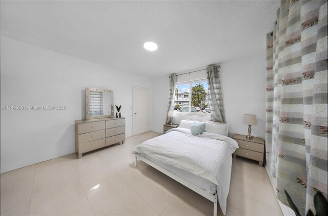 bedroom with light tile patterned floors