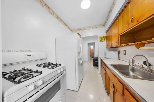 kitchen with white appliances, brown cabinetry, light countertops, a sink, and light tile patterned flooring